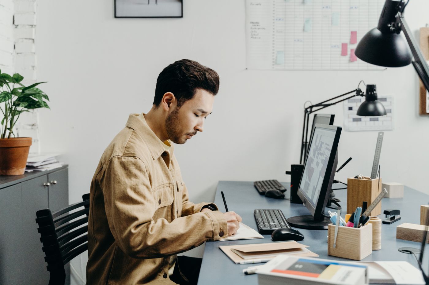 A building manager working at a desk computer
