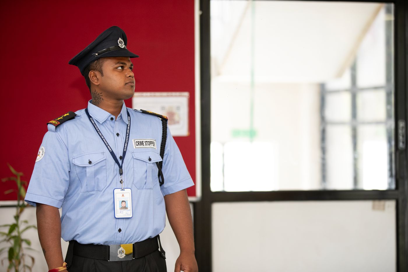 A security guard at a building entrance