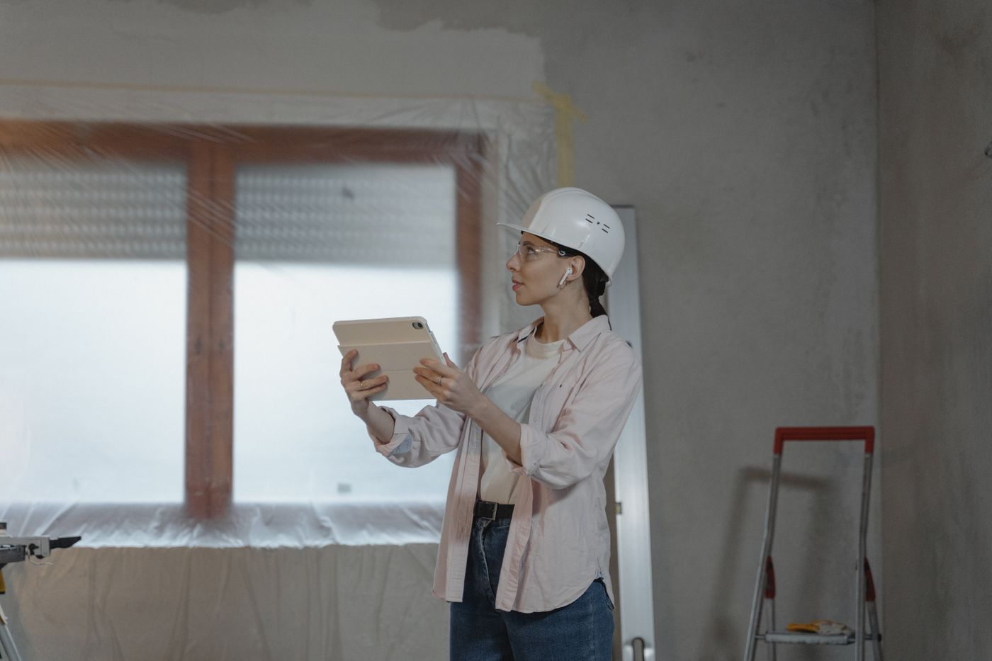 A site engineer checking plans on a tablet