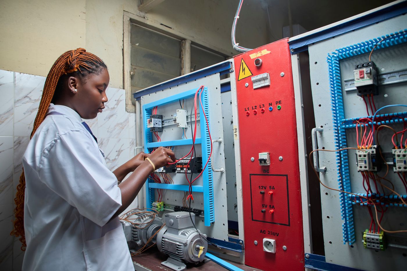 A technician working on an electrical control panel