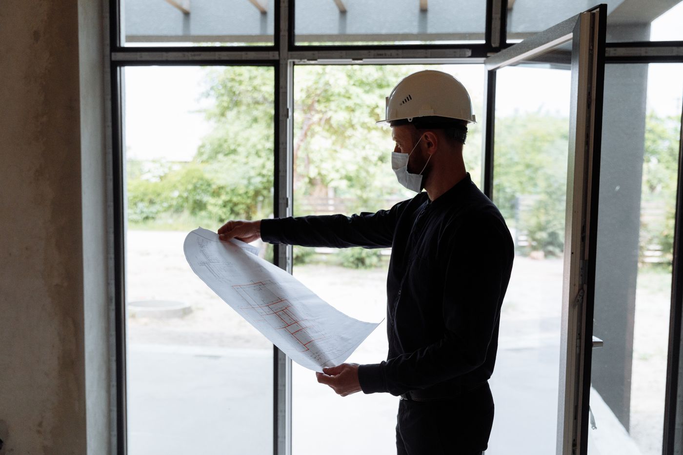 A site engineer reviewing plans in a new building