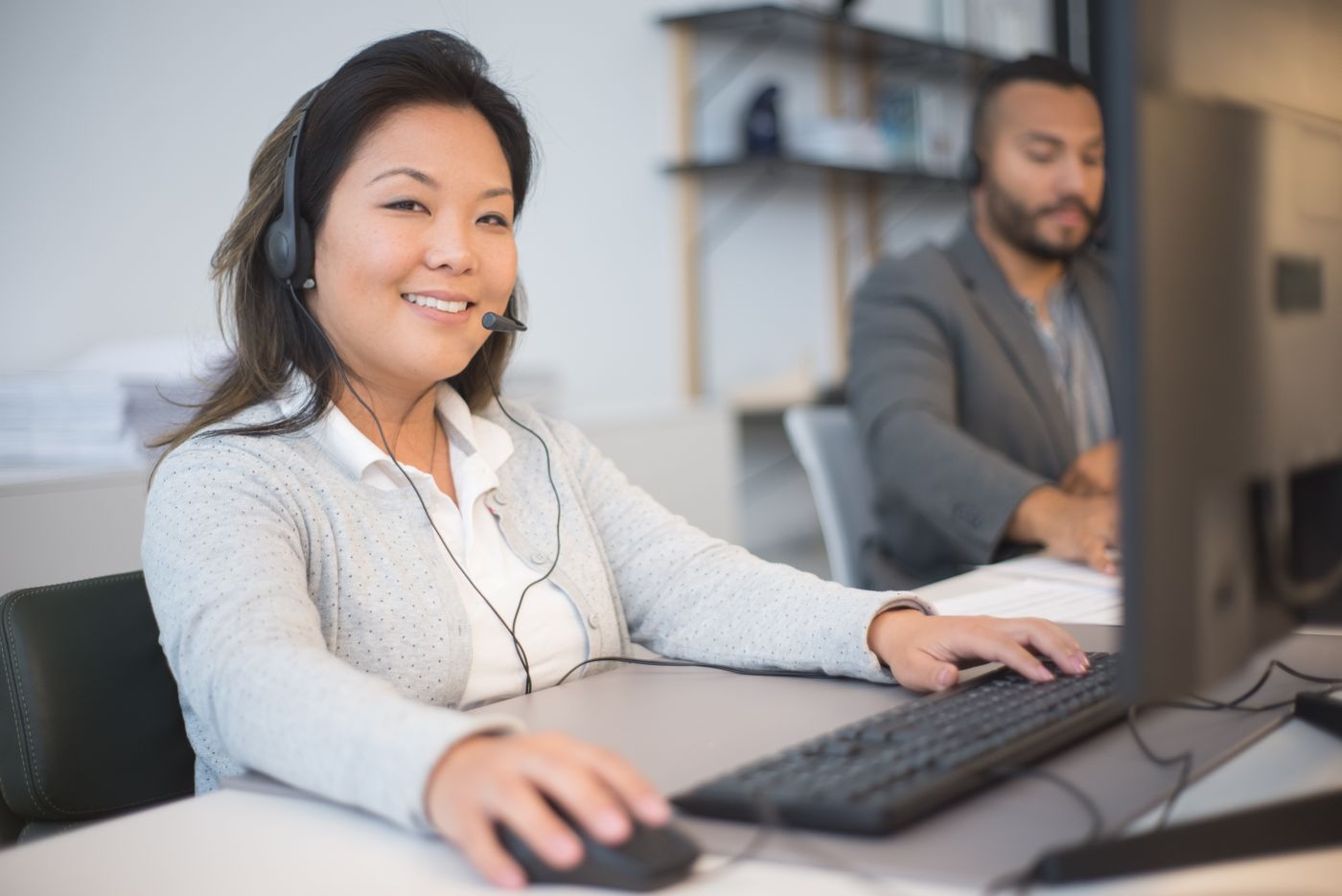 Two members of the team on calls at their desks